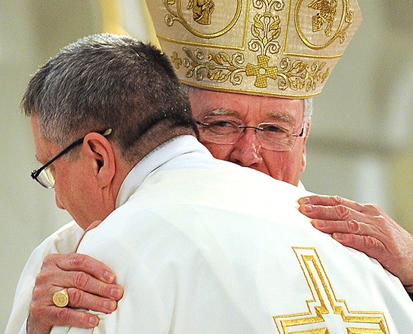 Bishop Richard J. Malone hugs Father Gerard Skrzynski during a Mass at St. Joseph Cathedral where the four men were ordained into the priesthood. Father Skrzynski is assignment to St. Vincent de Paul Church in Niagara Falls. (Dan Cappellazzo/Staff Photographer)